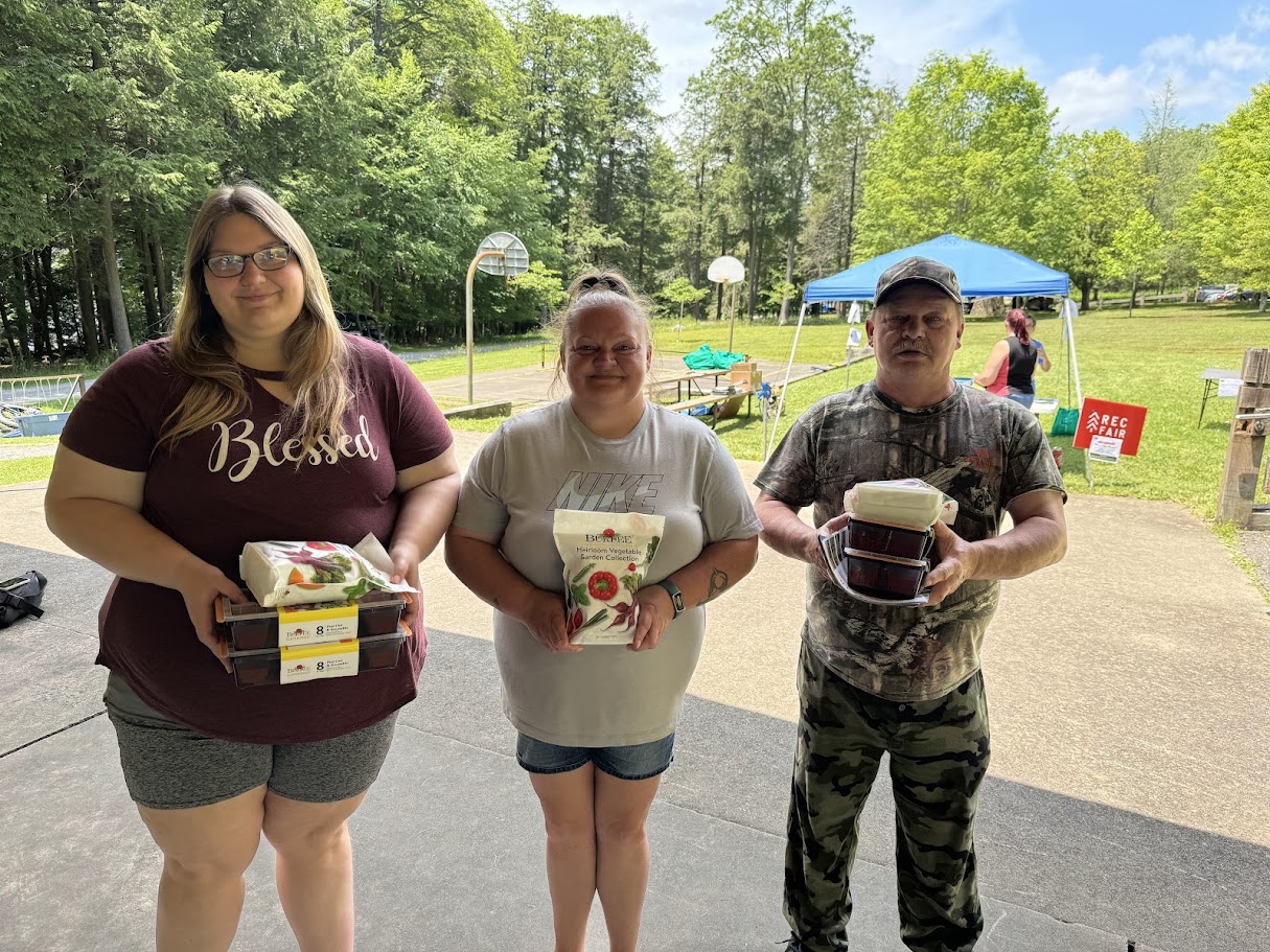Photo: Food system sustainability and resiliency came up often in listening sessions. As a result, we also explored aspects of victory gardens for 360 Access Hub. These kits (shown above) were provided with online education at the Garrett County Rec Fair at Deep Creek Lake State Park while we continued to prepare the physical space. Program participants were also able to get a food voucher to Casselman Market to address immediate needs. My new friend, Samantha (shown center), helped drive people to this event and others as we addressed needs prior to the opening of 360 Access Hub.